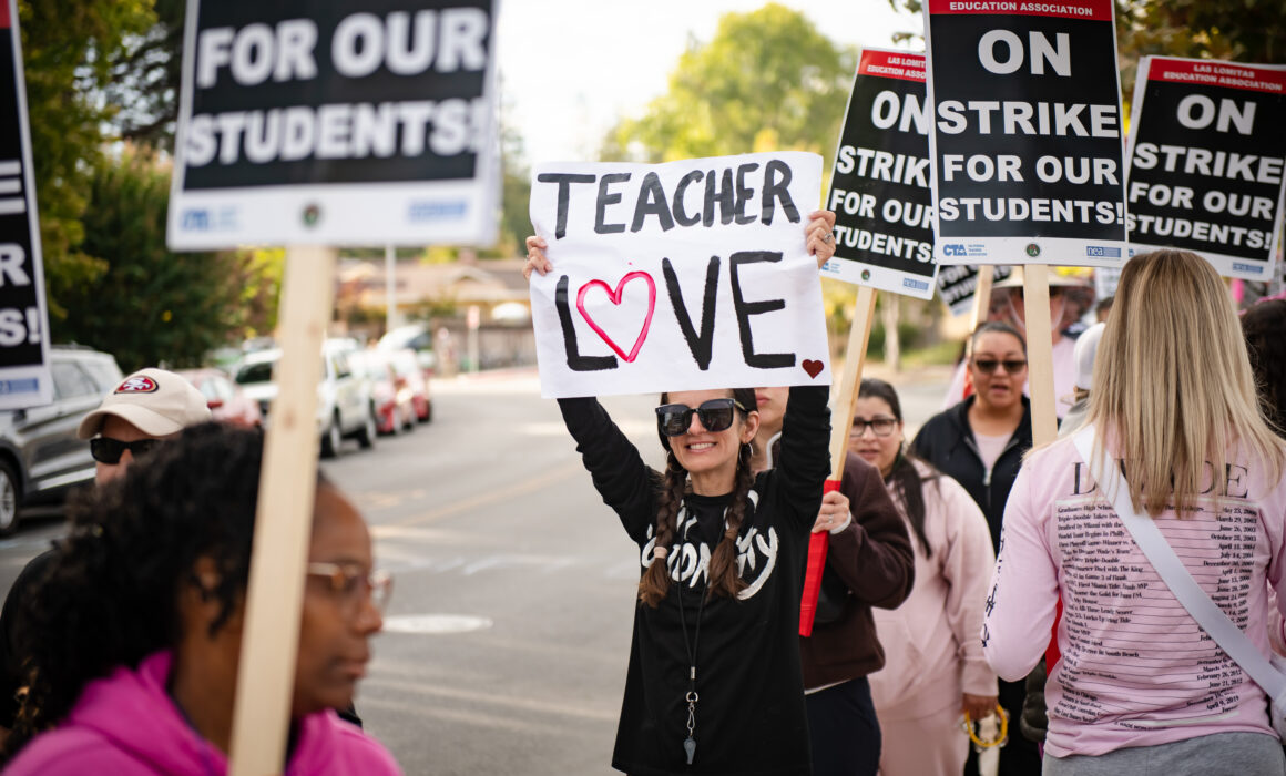 Las Lomitas Education Association member pictured with sign saying "Teacher Love".