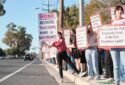 Anaheim Secondary Teachers Association members with signs against layoffs