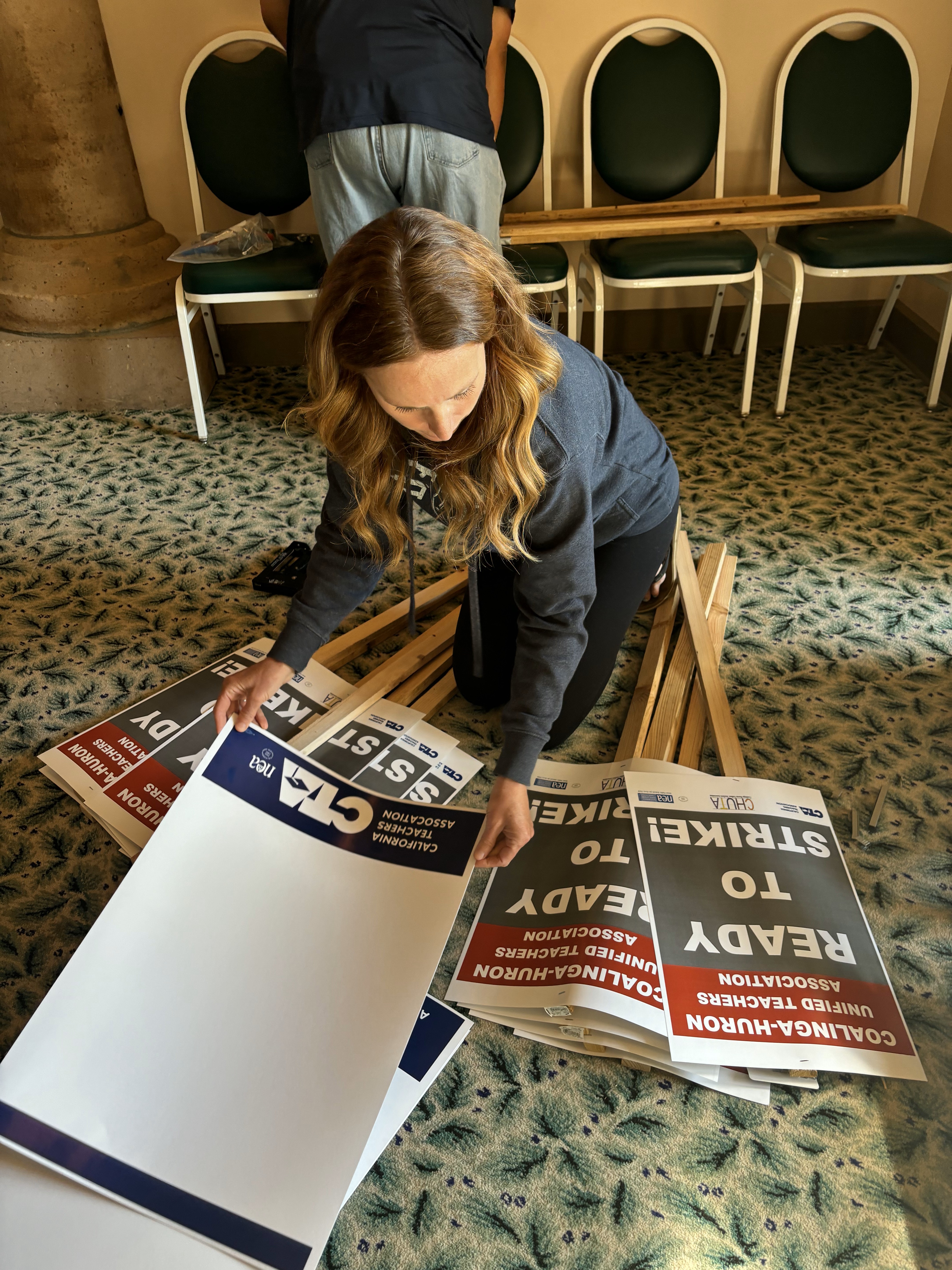 Photo of Coalinga-Huron member working with ready to strike flyers