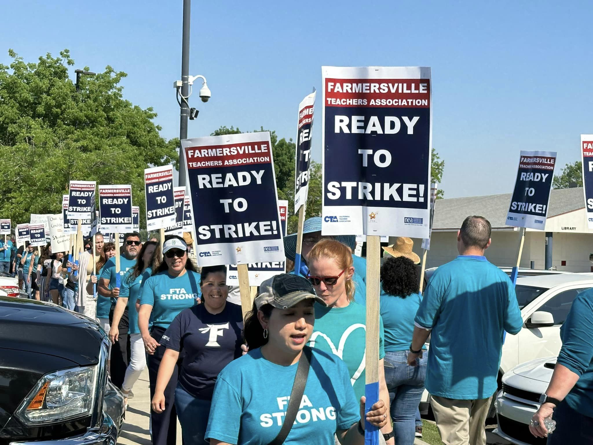 Photo of Farmermsville Teachers Association members with ready to strike signs