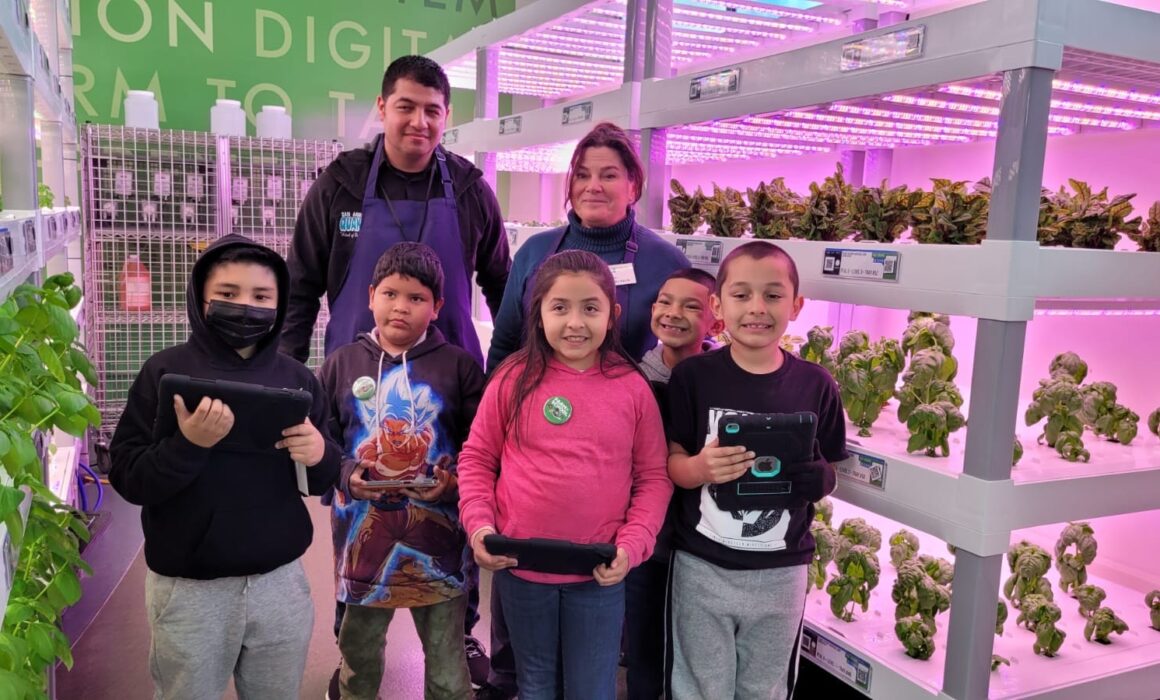 Educators Hector Magallanes and Barbara Pastuschek-Cox with students inside the hydroponic growing facility at San Andreas High.