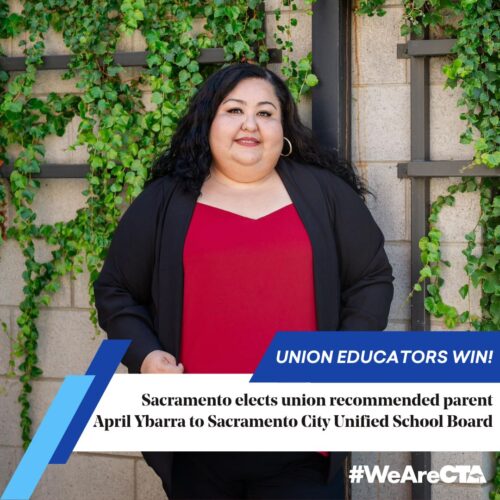 Union educator April Ybarra poses for a photo wearing a red shirt and black coat.